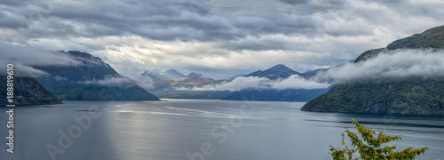 Panorama. Beautiful Norwegian fjord with mountains in the background before the rain