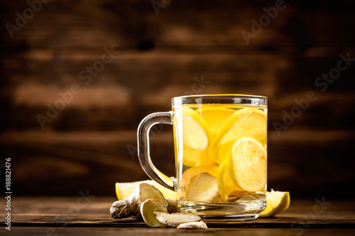 hot sweet ginger tea with lemon in glass mug