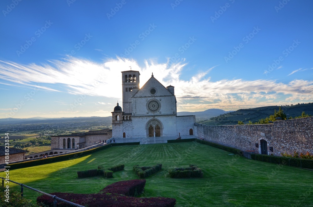 Front view of the Basilica of Saint Francis of Assisi. Sunshine spikes from behind the basilica, coloring the yellow cloud 12 August 2016 Front view of the Basilica of Saint Francis of Assisi. Sunshine spikes from behind the basilica, coloring the yellow cloud 12 August 2016