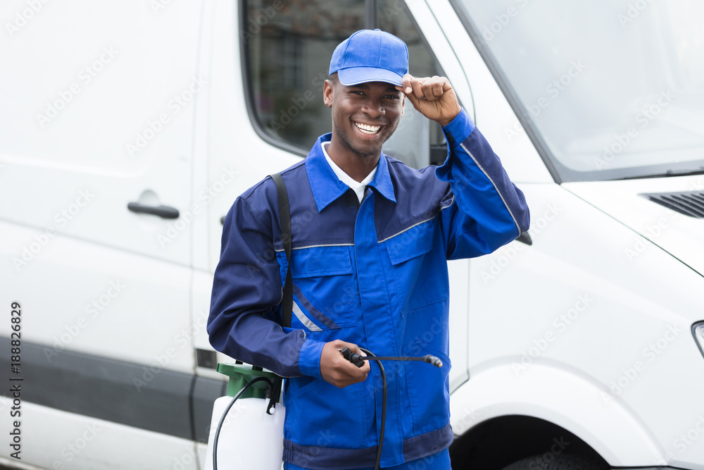 Young Smiling Male Worker With Pesticide Sprayer