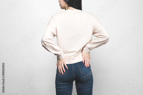 rear view of young woman in blank sweatshirt on white