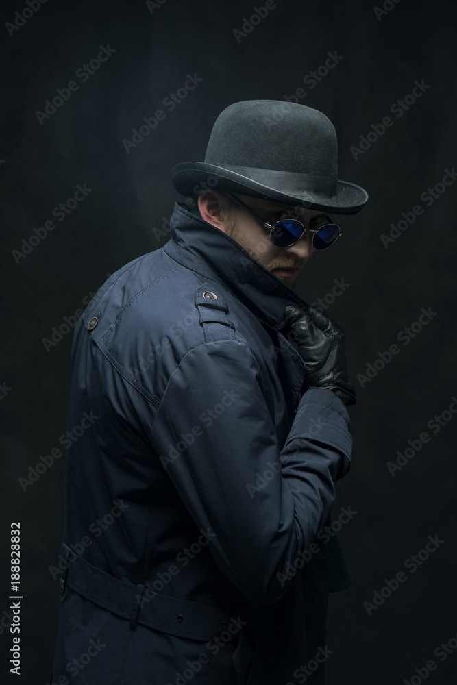 Robber in a hat, glasses and black gloves Robber in a hat, glasses and black gloves