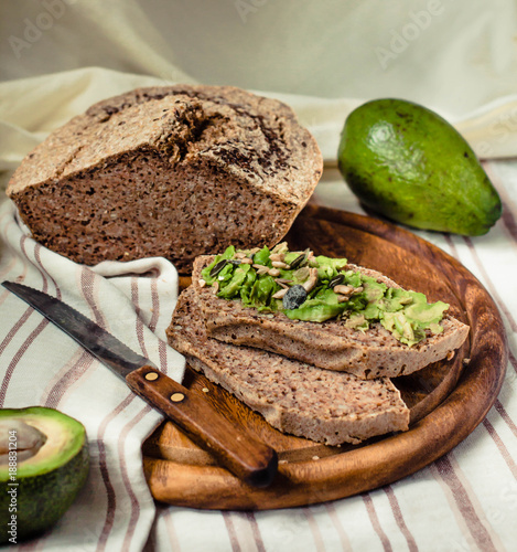 Avocado toast on gluten-free bread, rustic background. Guacamole with pumpkin seeds.Vegetarian food and Superfood diet concept.