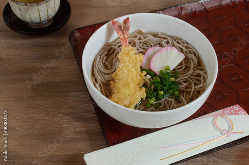 Toshikoshi soba, year-crossing noodle, is Japanese traditional noodle bowl dish eaten on New Year's Eve. This custom lets go of hardship of the year because soba noodles are easily cut while eating. photo