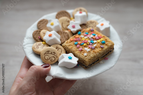 Variety of sweet festive cookies on a wooden background photo