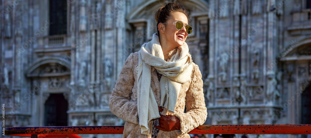 happy traveller woman in Milan, Italy looking into distance