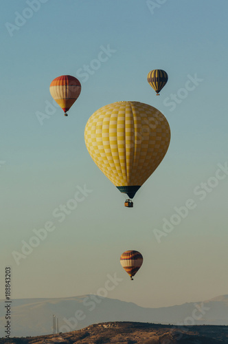 Hot air balloons festival in blue sky in Goreme national park, fairy chimneys, Cappadocia, Turkey
