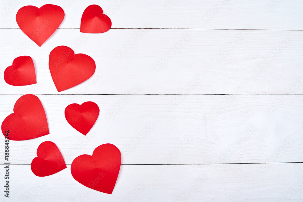 Top view of red paper hearts border on white wooden background, copy ...