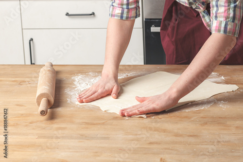 scene of homemade cooking - housewife cooks pastry in kitchen