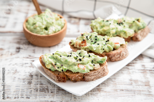 toast with guacamole, seeds and herbs. A cup of coffee. Healyhy Breakfast concept