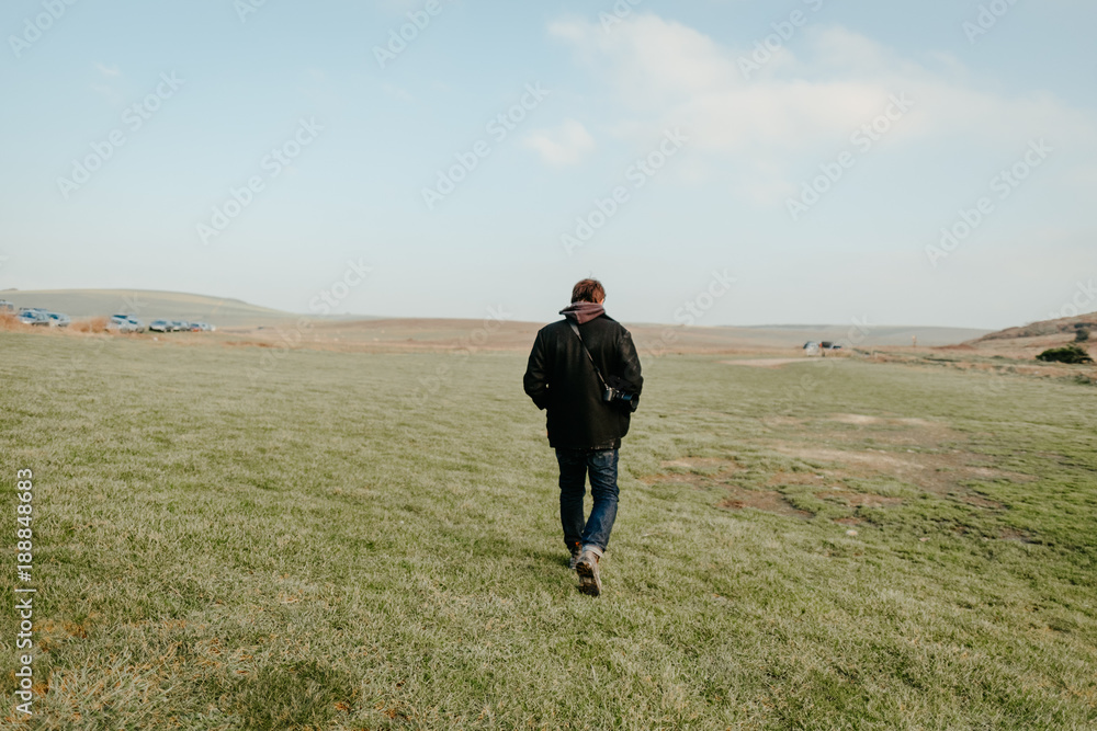 Male Backpacker walking alone in the wide nature England landscape Male Backpacker walking alone in the wide nature England landscape