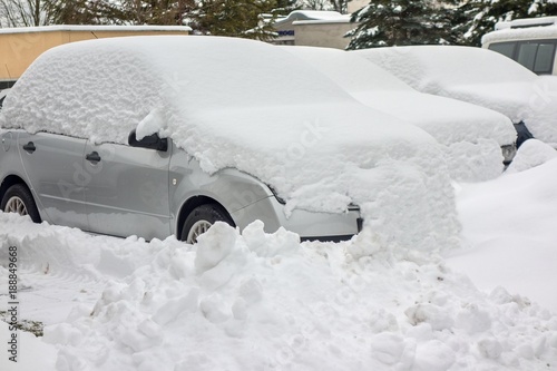 cars in a street covered by a lot of snow