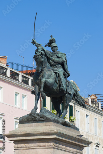 Sculpture of the king Victor of Emmanuil II (1887) close up against the background of the blue sky. Venice. Italy
