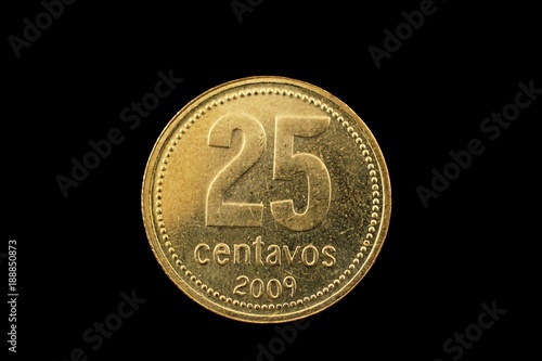 A super macro image of a gold argentinian twenty five centavo coin isolated on a black background