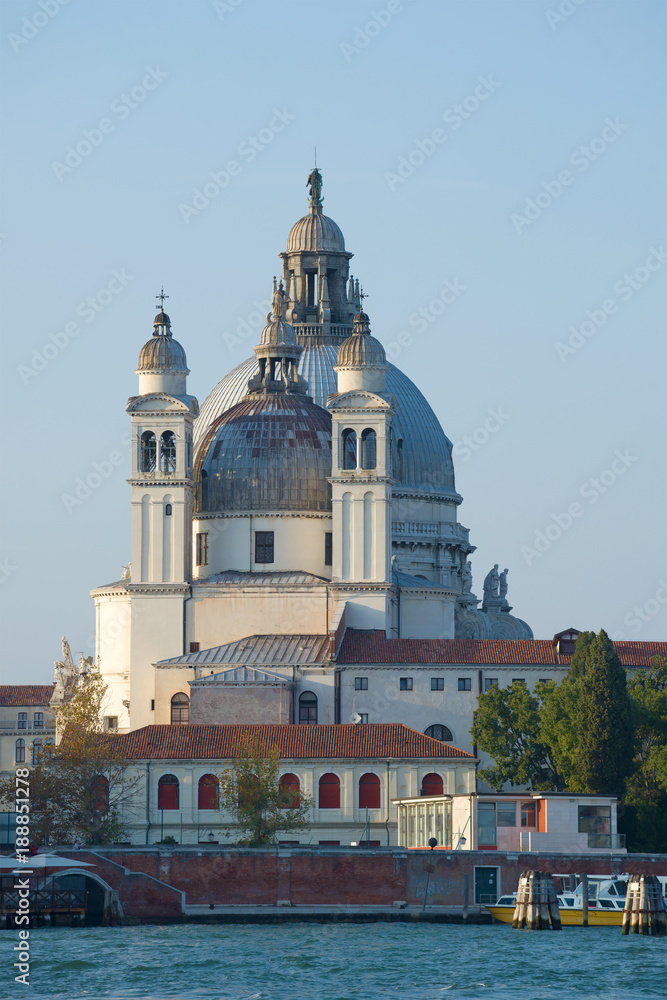 The bell tower and dome of cathedral of Santa-Maria-della-Salyute against the background of the blue sky. Venice