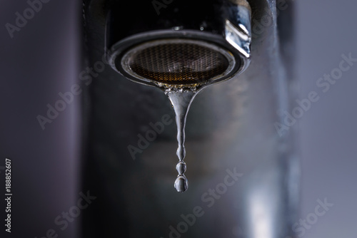 Bathroom tap leaking water drops
