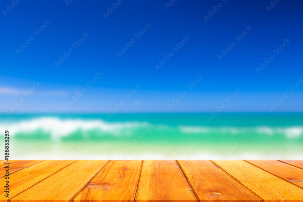 Wood plank with blurred sea background. Concept of beach in summer.