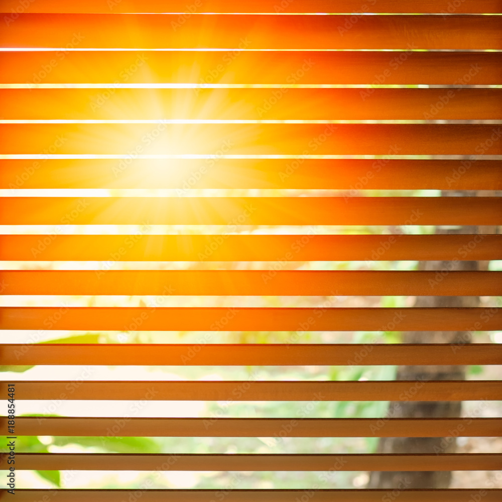 Wooden blinds with sun rays.