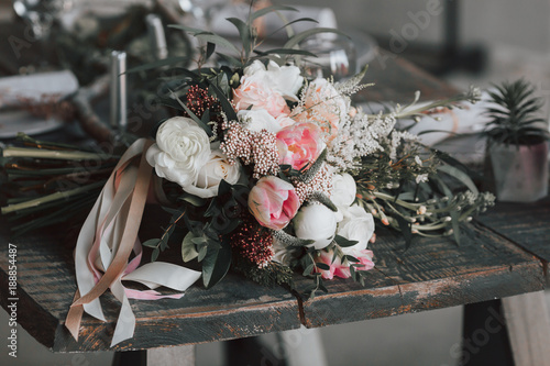 The rustic bouquet on an aged wooden table. Artwork.