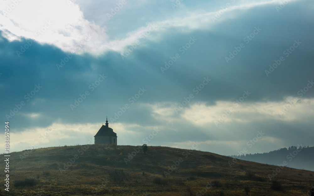 Beautiful landscape dramatic view of a lonely church on a hill