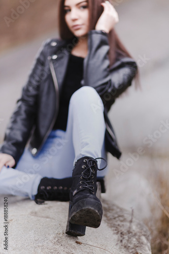 Young woman wearing trendy black lace-up boots