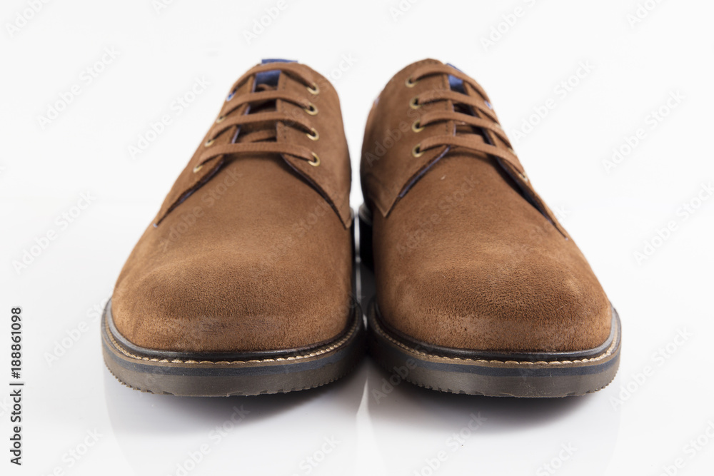 Male brown leather shoe on white background, isolated product, comfortable footwear. Male brown leather shoe on white background, isolated product, comfortable footwear.