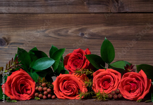Fototapeta Naklejka Na Ścianę i Meble -  Photo with closeup roses  bouquet on wooden background