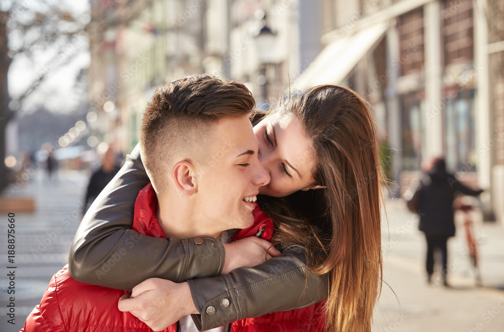 young couple, girl friend on his neck in spring