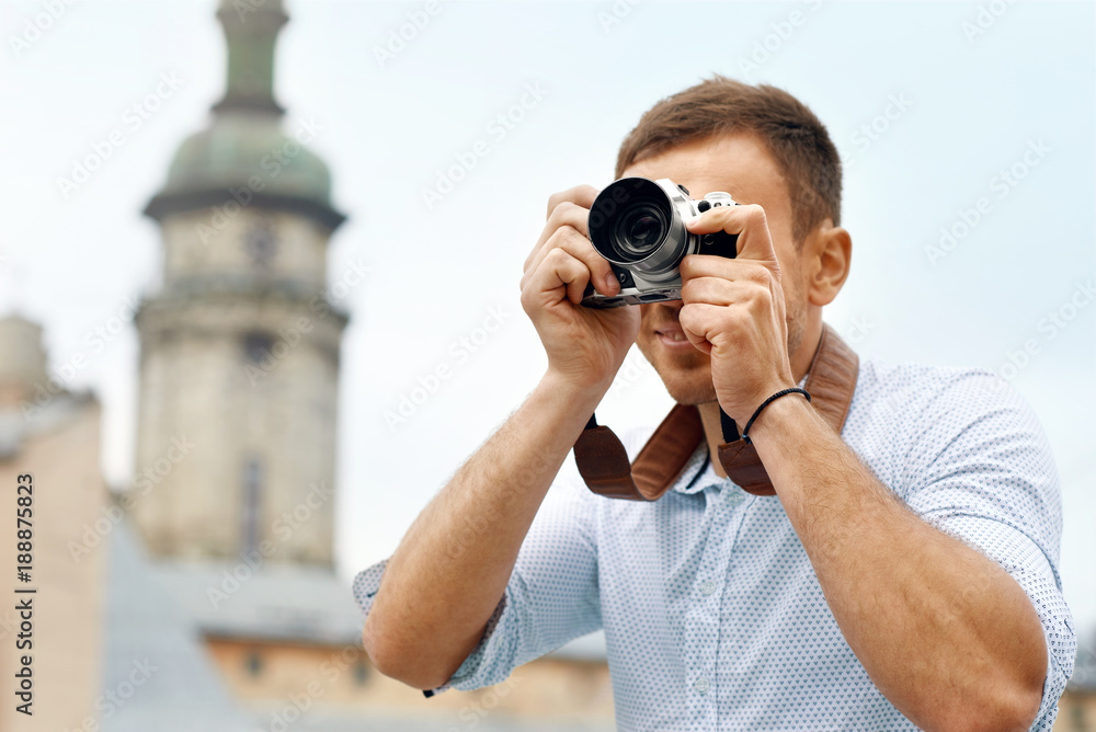 Tourist Man With Camera Taking Photos On Street.