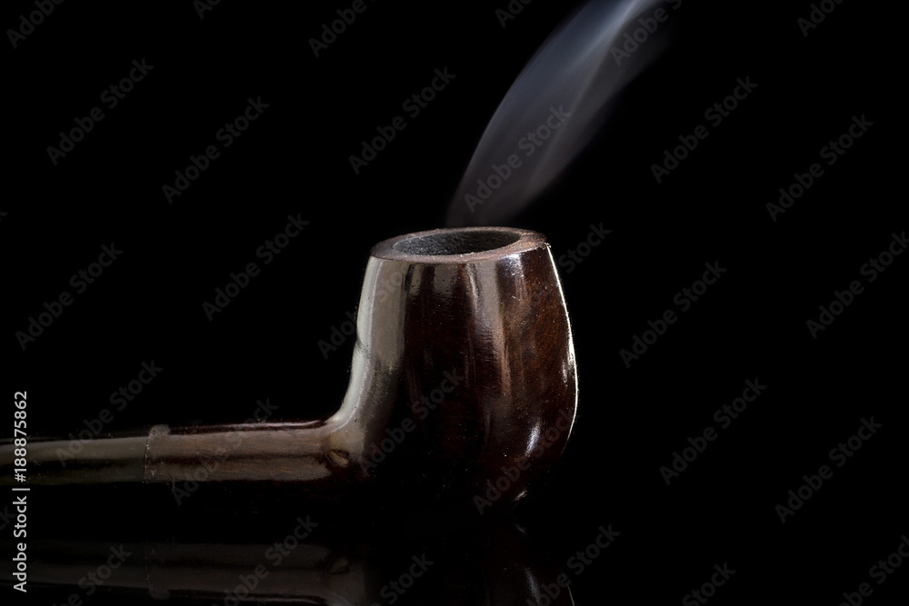Lit Tobacco Smoking pipe reflective glass surface, with moving smoke