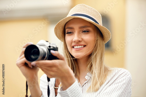 Woman Taking Photos On Camera On Street