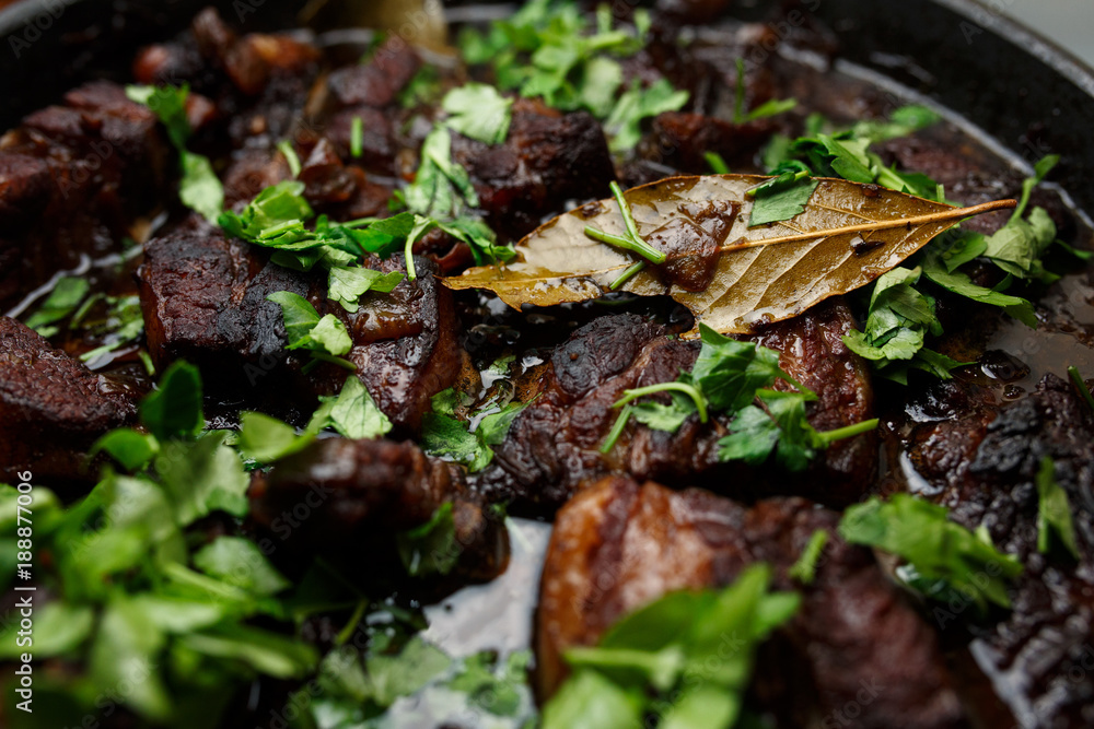 Finished pork ribs in the garnet sauce with greenery. Finished pork ribs in the garnet sauce with greenery.