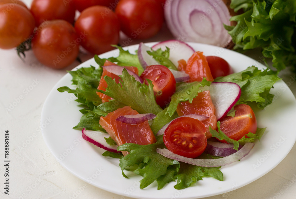 Fresh salad from salmon and vegetables.