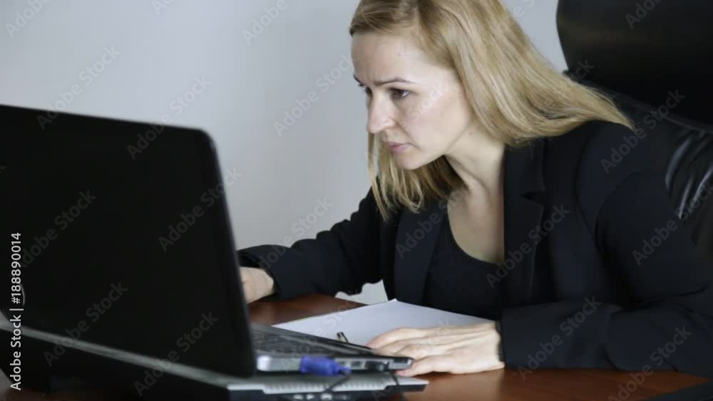 Businesswoman working on laptop in office. Work on a crypto stock exchange Businesswoman working on laptop in office. Work on a crypto stock exchange