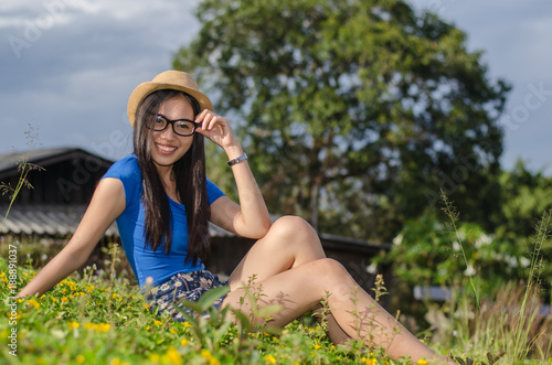 Happy Asians female in cowgirl hat and  wear glasses looking at camera with toothy smile