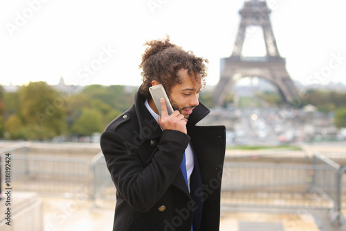 businessman talking with partner on smartphone near Eife photo