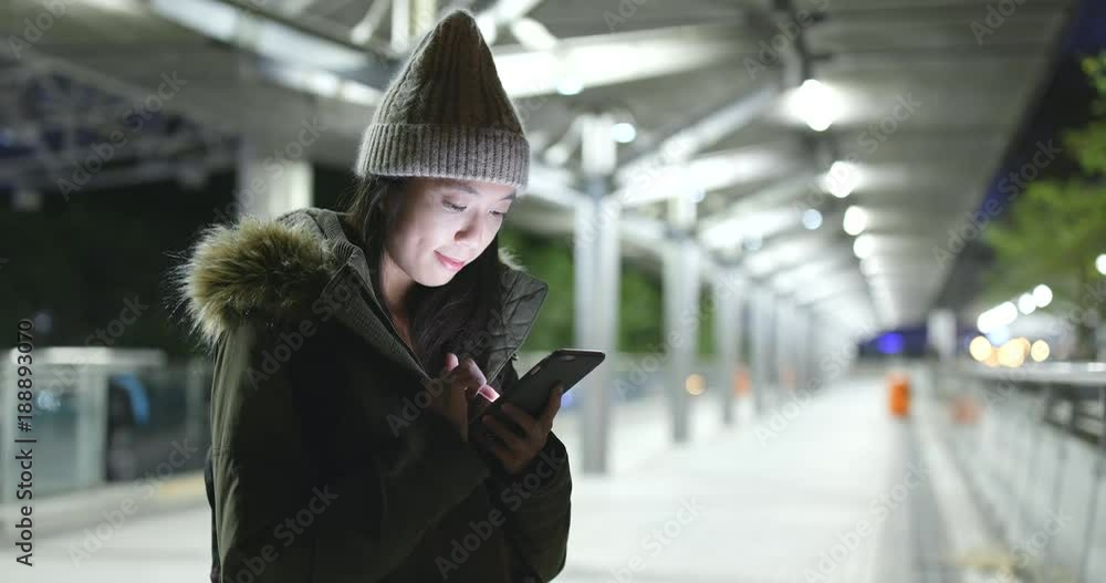 Asian Woman use of mobile phone in city at night Asian Woman use of mobile phone in city at night