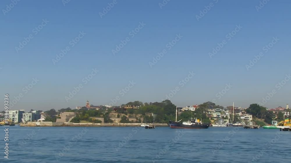 A wide shot of the ocean with ships and trees A wide shot of the ocean with ships and trees