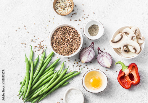 Flat lay healthy vegetarian food ingredients for lunch on a light background, top view. Buckwheat, green beans, sweet peppers, red onion, mushrooms - clean eating vegetarian food concept photo