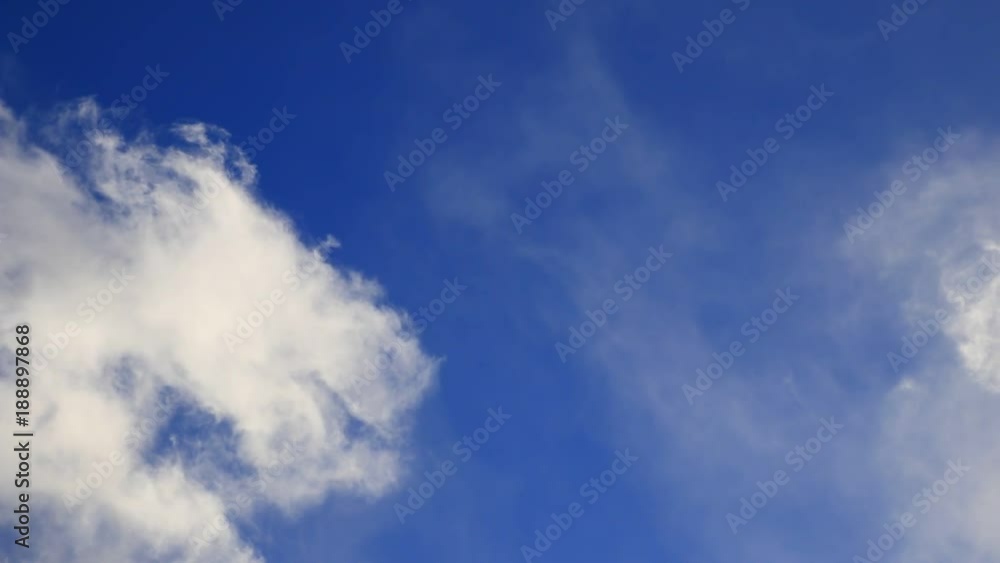 White clouds moving slowly in a blue sky White clouds moving slowly in a blue sky