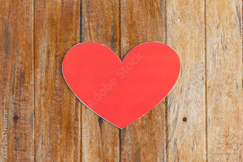 Red paper heart on wooden background with vintage tone  love and valentine concept