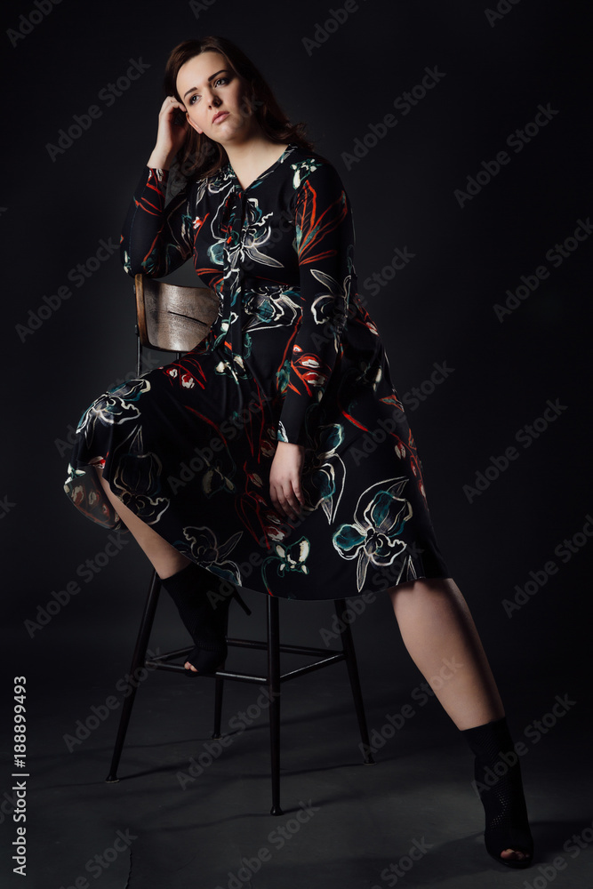 Naklejka premium portrait plus size fashion model fat woman on gray studio background, overweight female body.