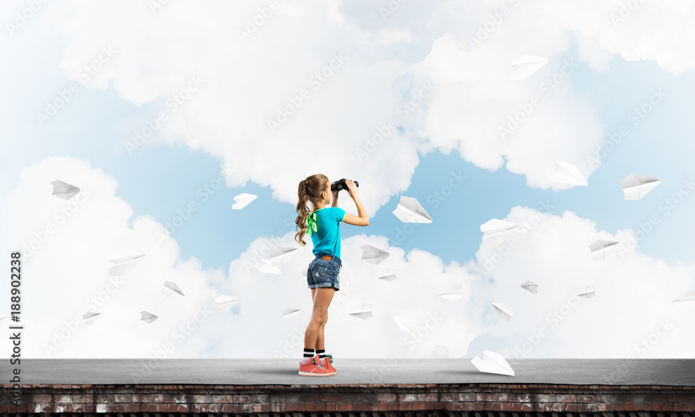 Concept of careless happy childhood with girl of school age looking in future Concept of careless happy childhood with girl of school age looking in future