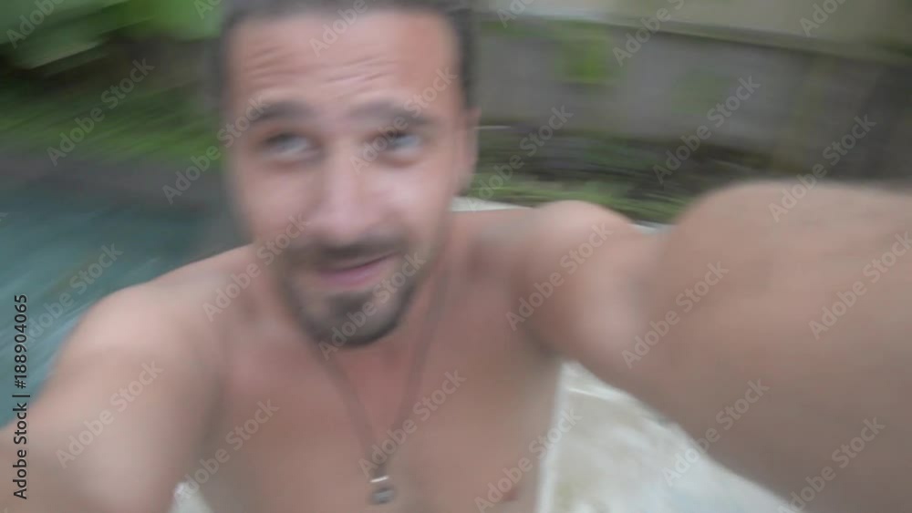 Young adult man spinning around on beach having fun taking video selfie. Closeup, hand held, outdoor sunny daylight shot. Young adult man spinning around on beach having fun taking video selfie. Closeup, hand held, outdoor sunny daylight shot.