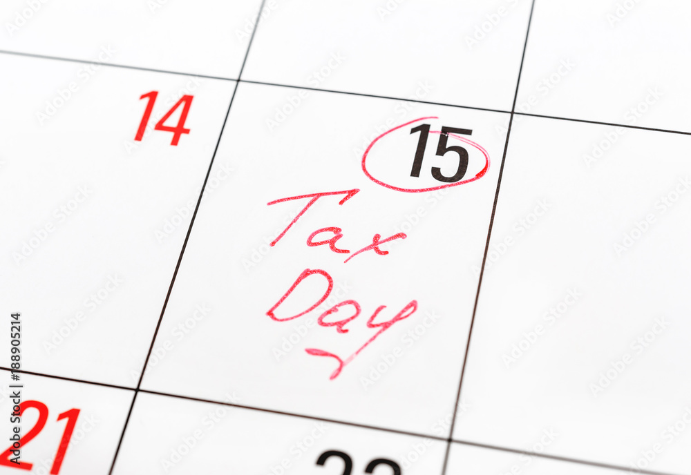 Tax day written on the calendar and circled 15th day by marker. Tax pay Deadline concept. Tax day written on the calendar and circled 15th day by marker. Tax pay Deadline concept.