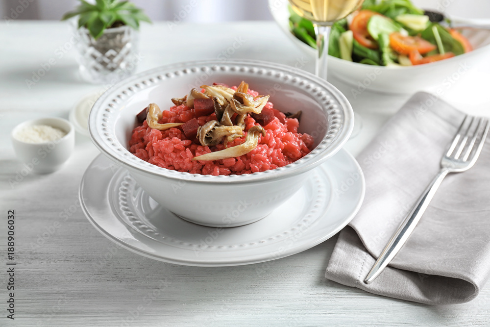 Dish with tasty risotto with mushrooms on table Dish with tasty risotto with mushrooms on table