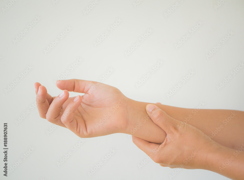 Close up young woman holding her wrist symptomatic Office Syndrome. Healthcare and arm pain concept. Close up young woman holding her wrist symptomatic Office Syndrome. Healthcare and arm pain concept.