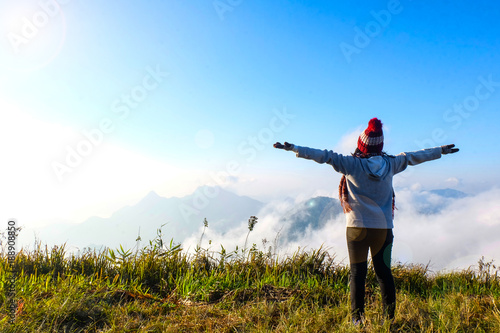 Girl stan and look at the sky. Freedom and happy and cold. Top of mountain and mist © Aom