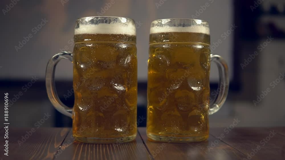 glasses of beer on the background of a football match