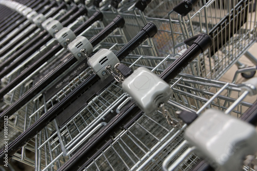 Many empty shopping carts in a row